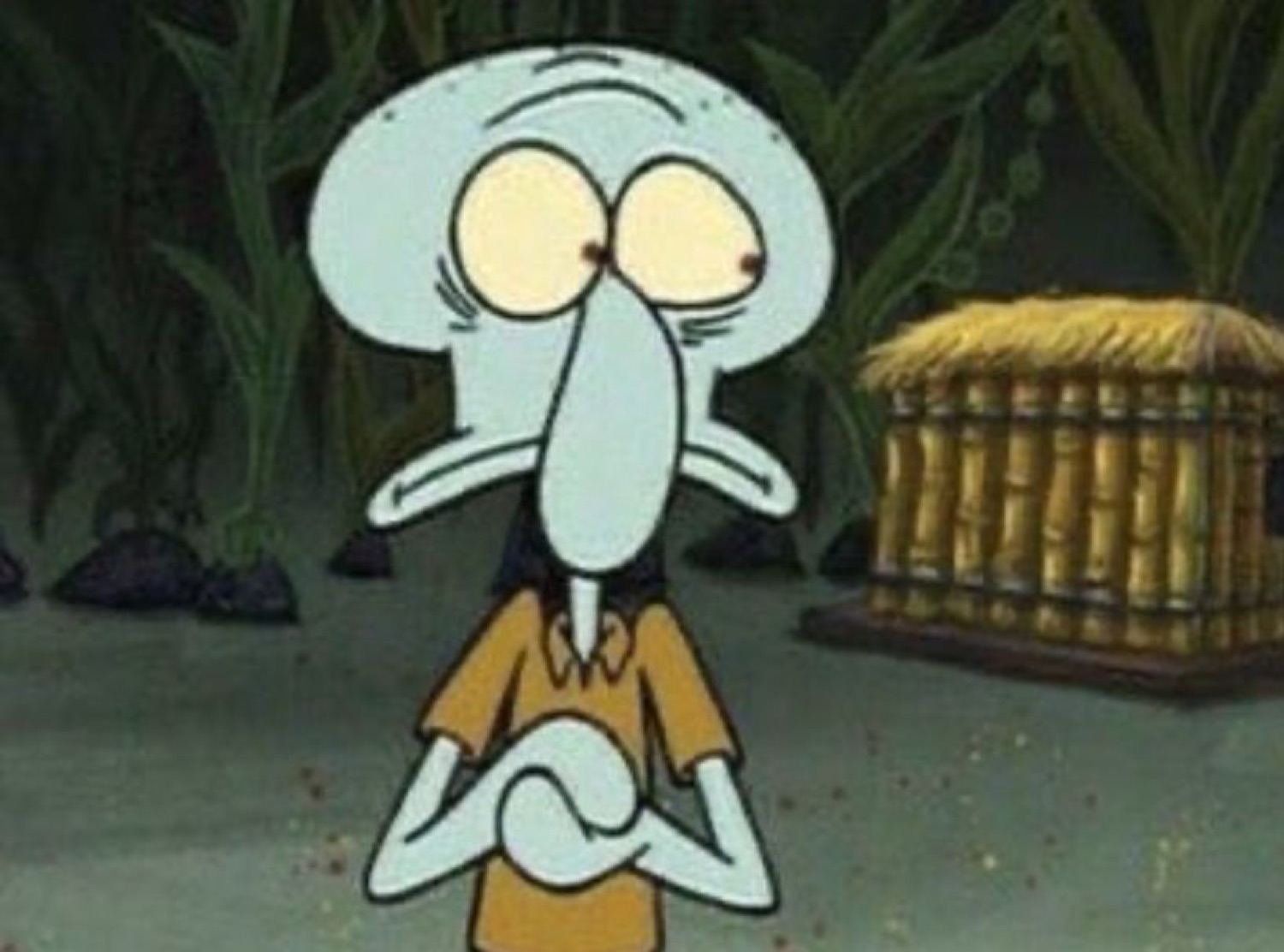 Squidward with wide eyes and nervously clasped hands