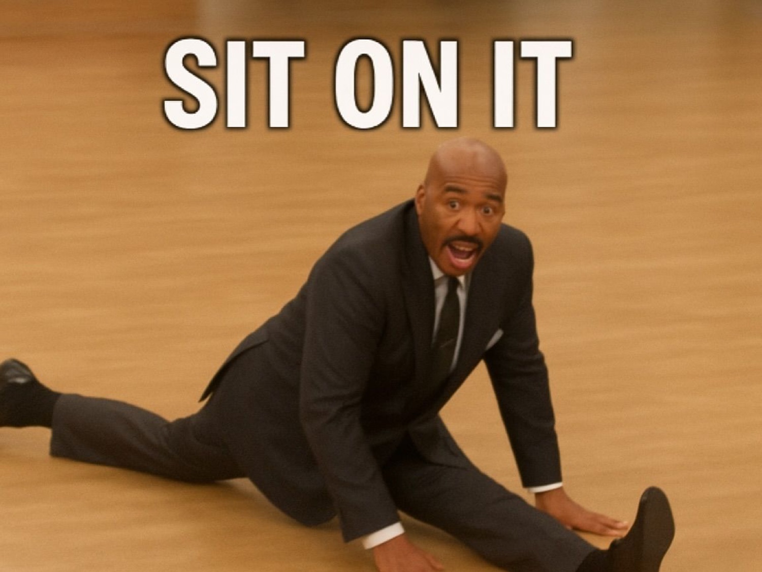 Steve Harvey on the floor doing the splits looking absolutely shocked, captioned 'SIT ON IT'