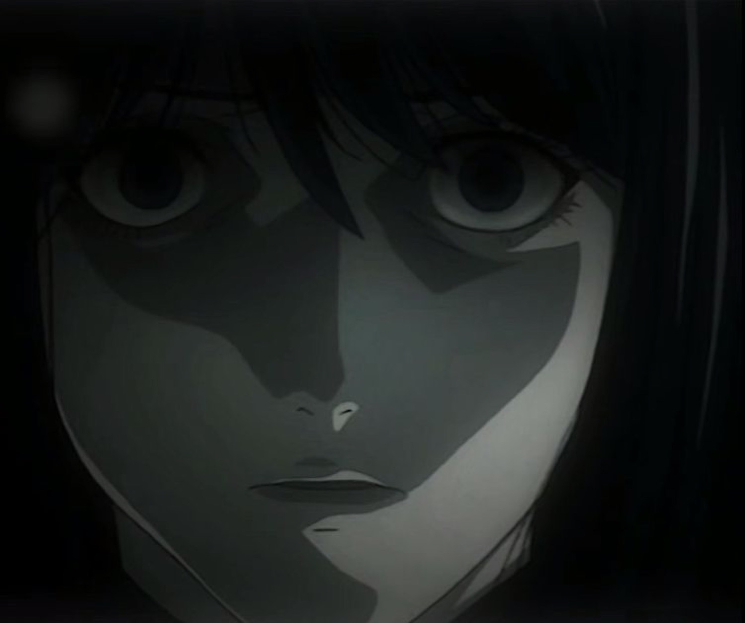 L from Death Note staring forward from the shadows with his trademark hollow, unblinking gaze