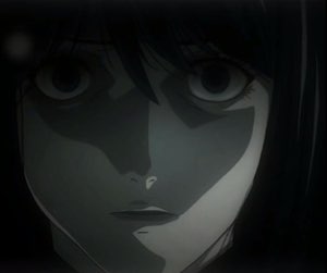 L from Death Note staring forward from the shadows with his trademark hollow, unblinking gaze