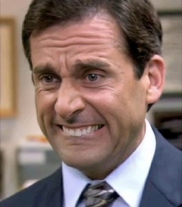 Michael Scott from The Office wincing through a tight, pained forced smile