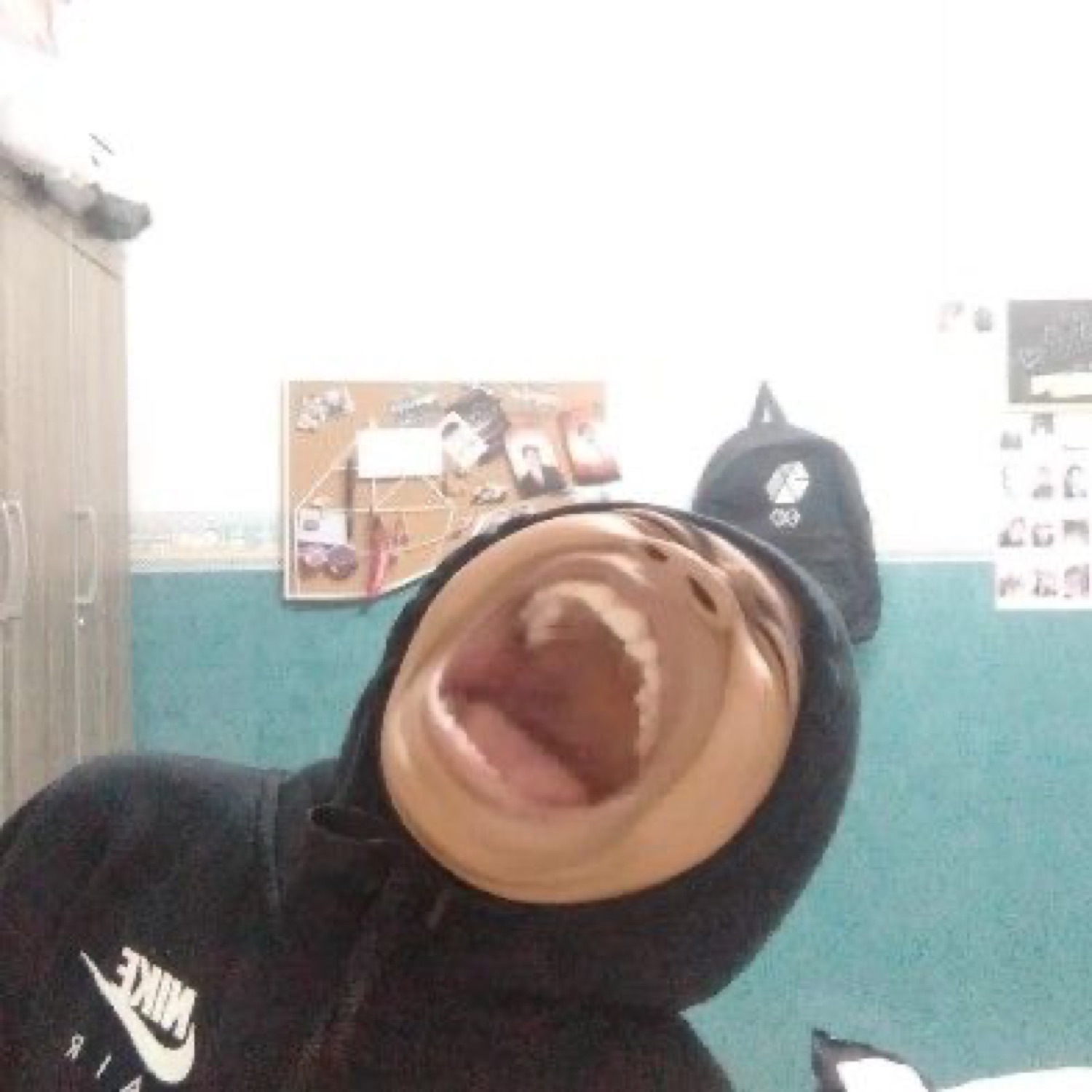 Person tilting head back mouth wide open in a full-volume laugh or scream