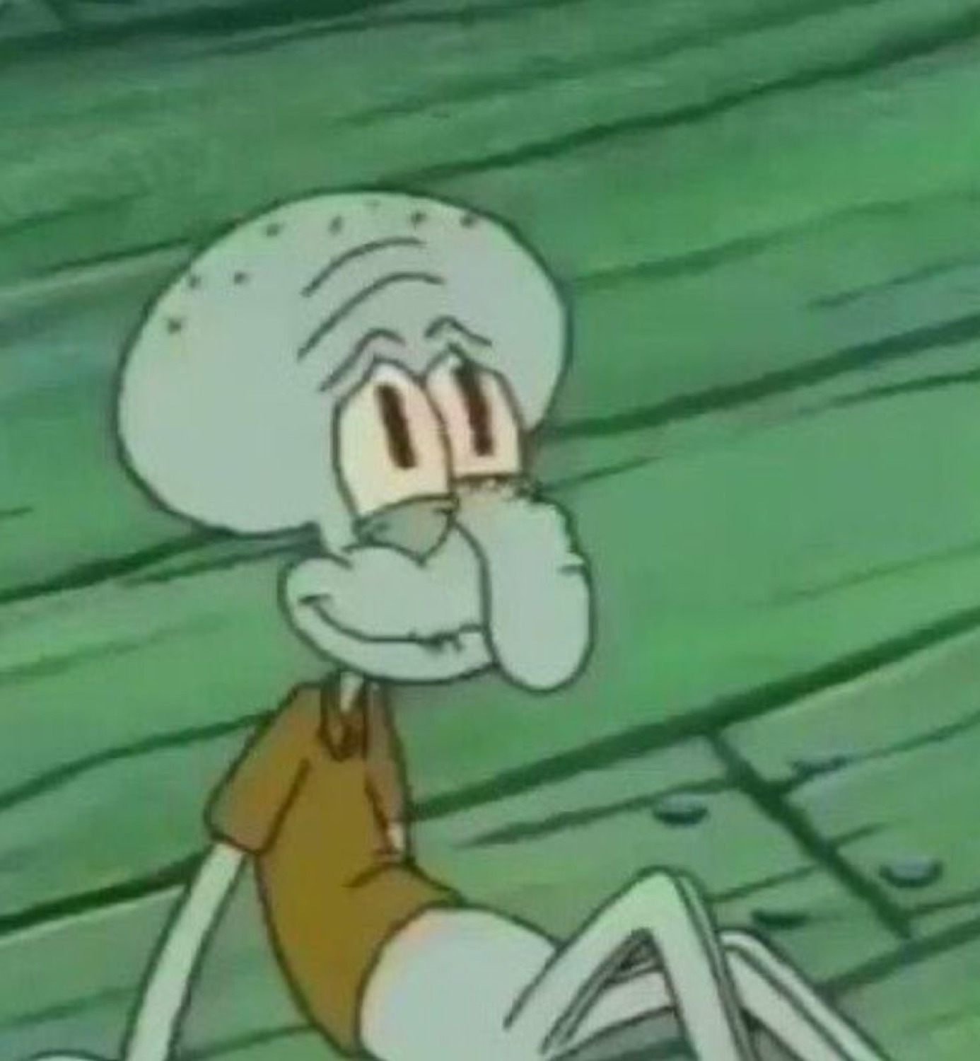 Squidward sitting and resting his face on his hand with a smug self-satisfied smirk
