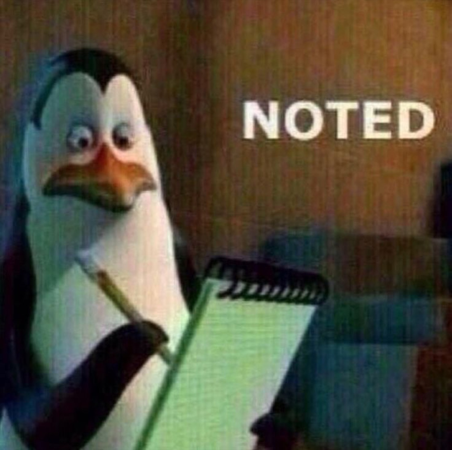 Madagascar penguin scribbling on a notepad next to the word 'NOTED'