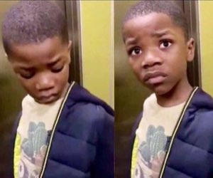 Young boy in an elevator looking down then up with a hurt, about-to-cry face