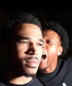 One guy staring straight ahead unbothered while a friend yells right in his ear