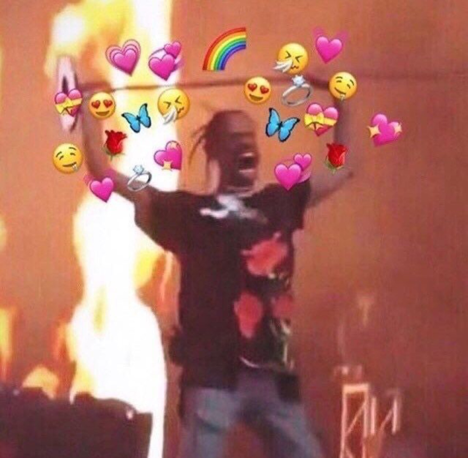 Man screaming on a fiery stage, framed by a wholesome swarm of heart emojis