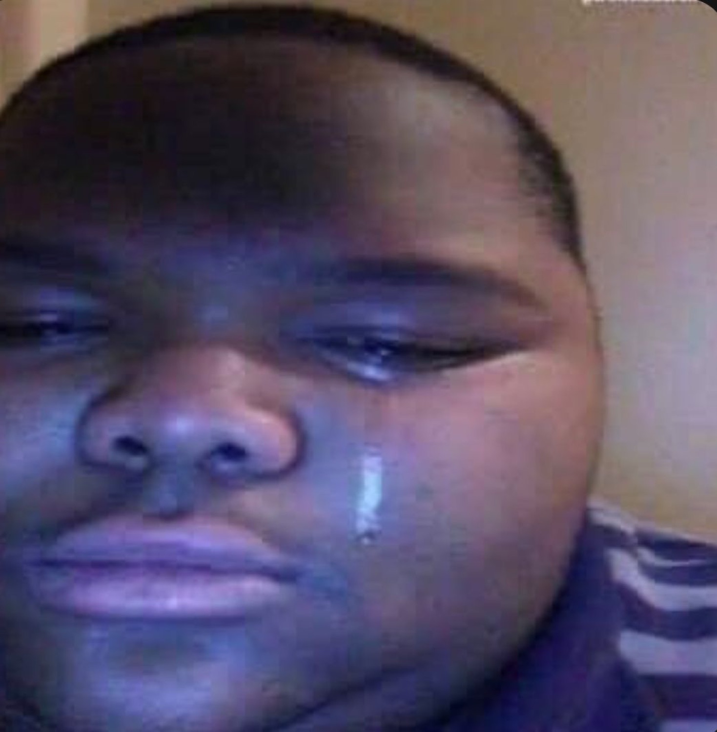 Man with a single tear rolling down his cheek staring quietly ahead