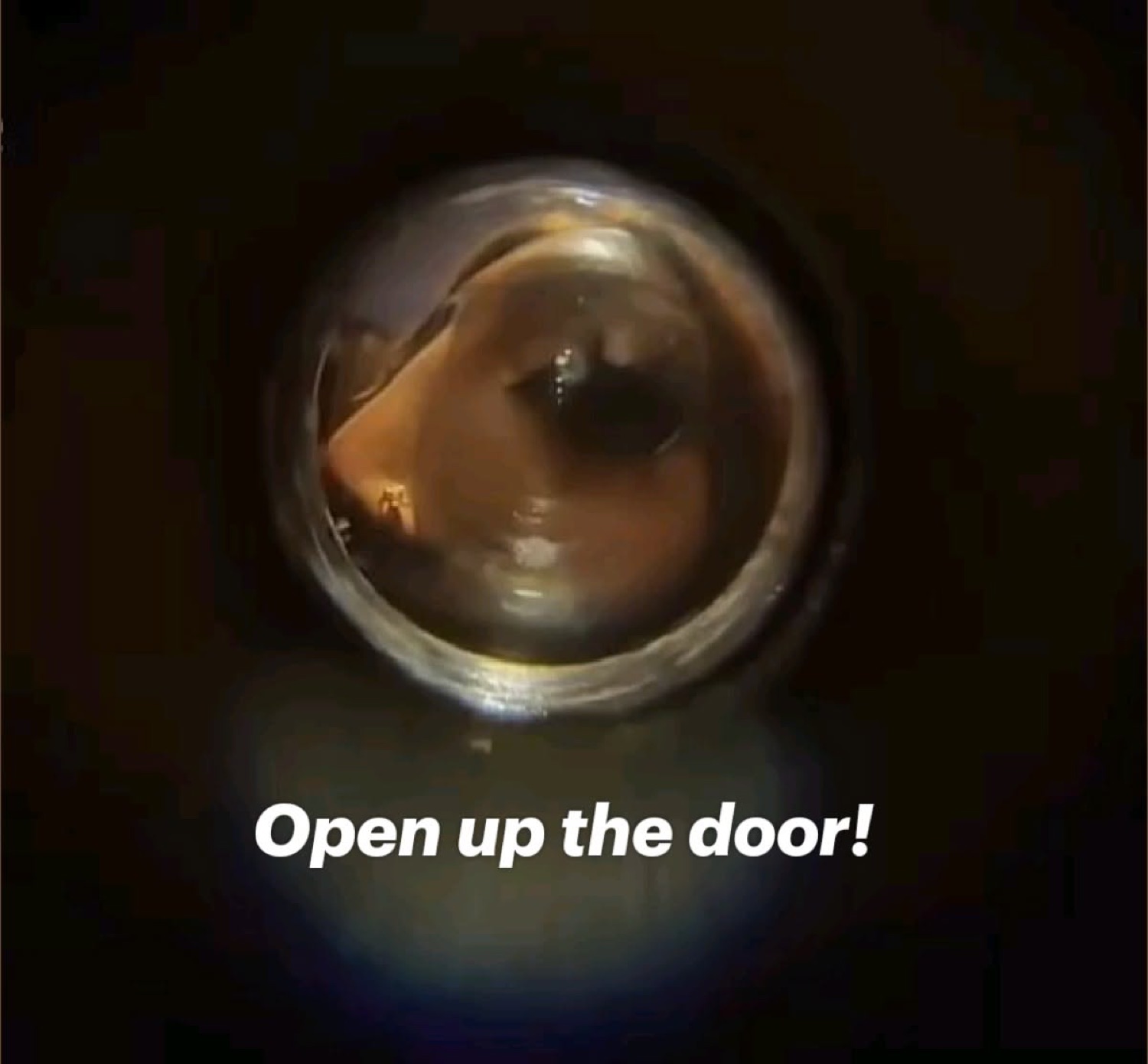Dark view through a door peephole under 'Open up the door!'