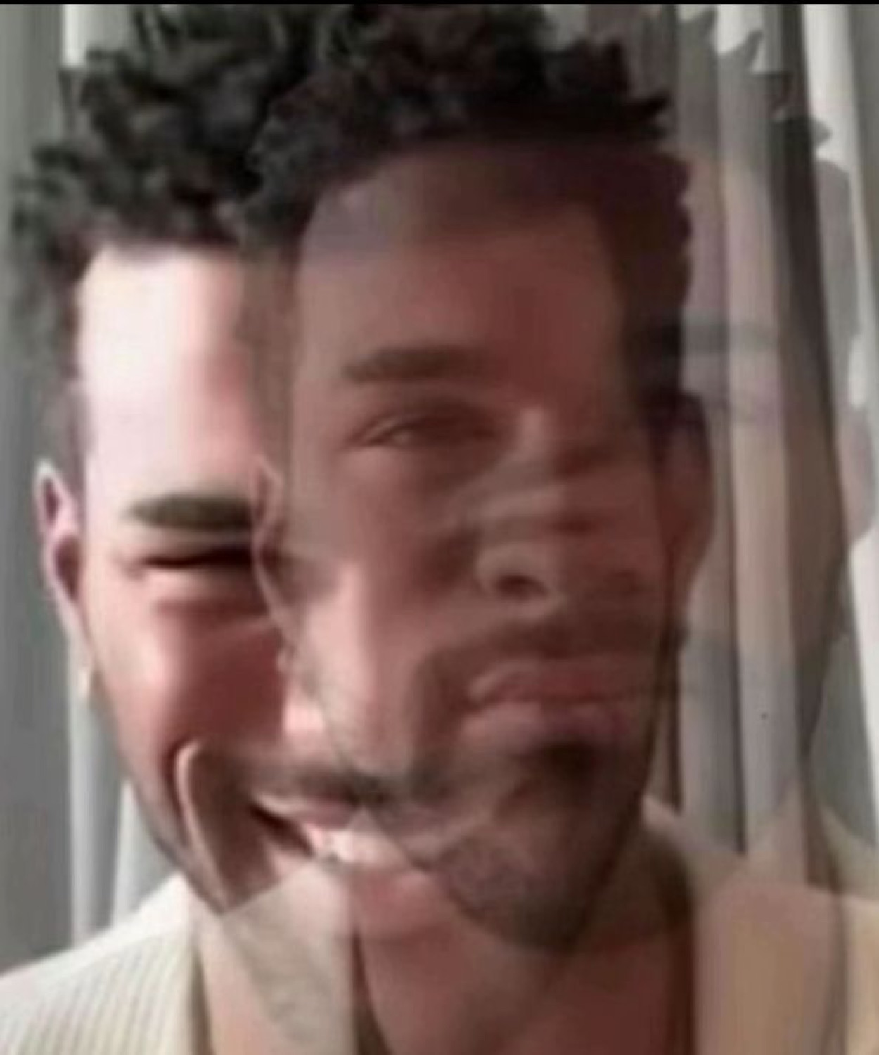 A blurry double-exposed selfie of a man that looks like his soul is glitching out
