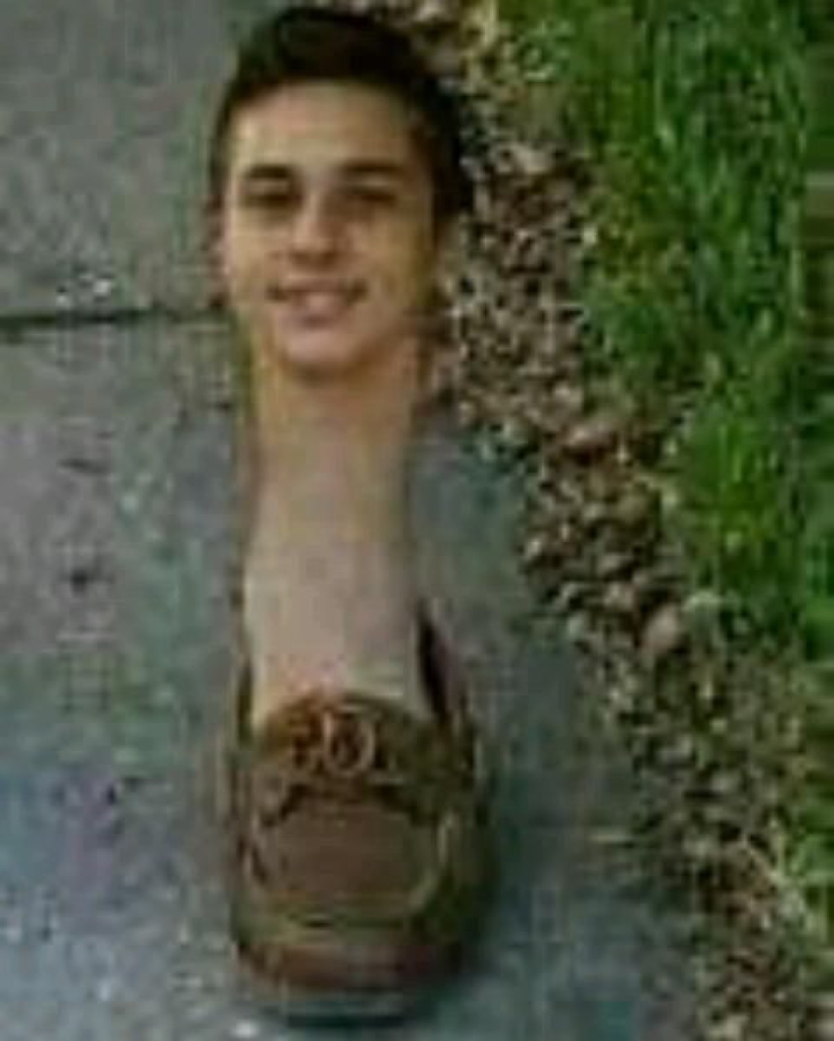 Warped photo of a smiling boy's face morphed onto a shoe on a sidewalk