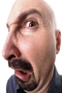 Bald man with a mustache leaning in and sneering with visible disgust