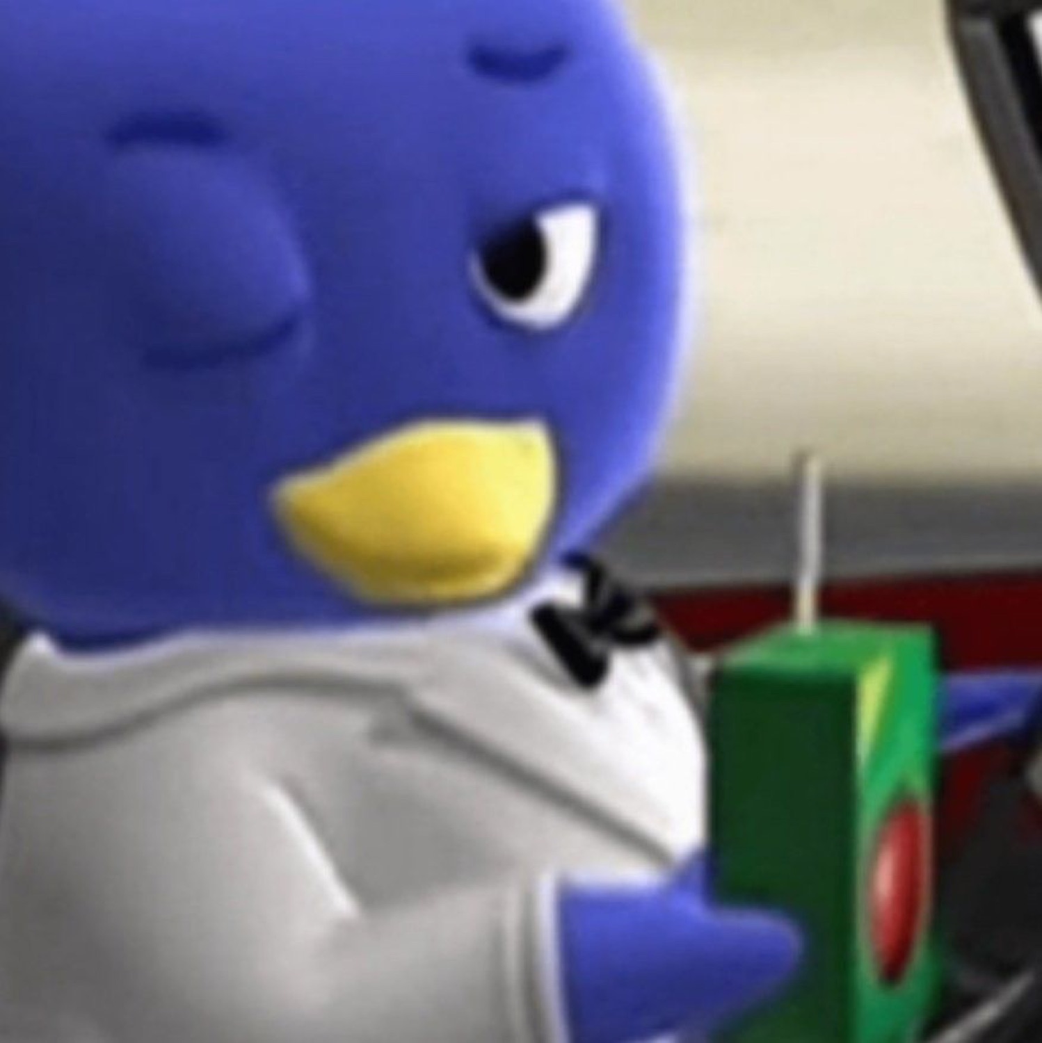 Pablo the Backyardigans penguin side-eyeing something very hard while holding a present