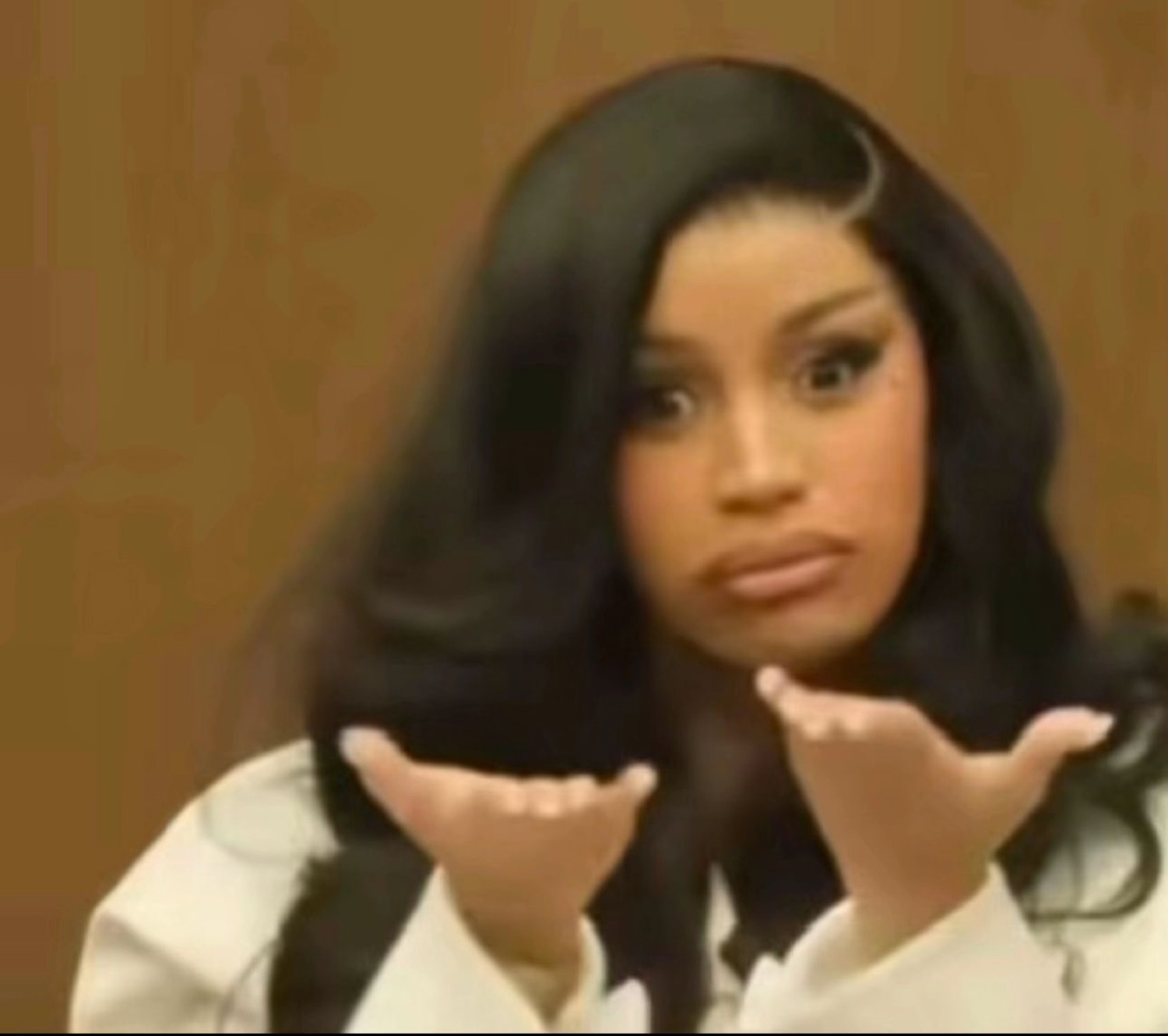 Cardi B holding both palms up in courtroom with a baffled, what-do-you-want look
