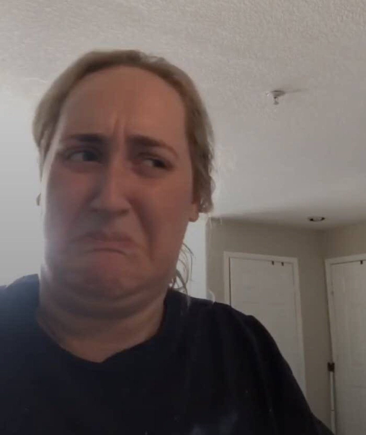 Woman side-eyeing the camera with a disgusted, unimpressed grimace
