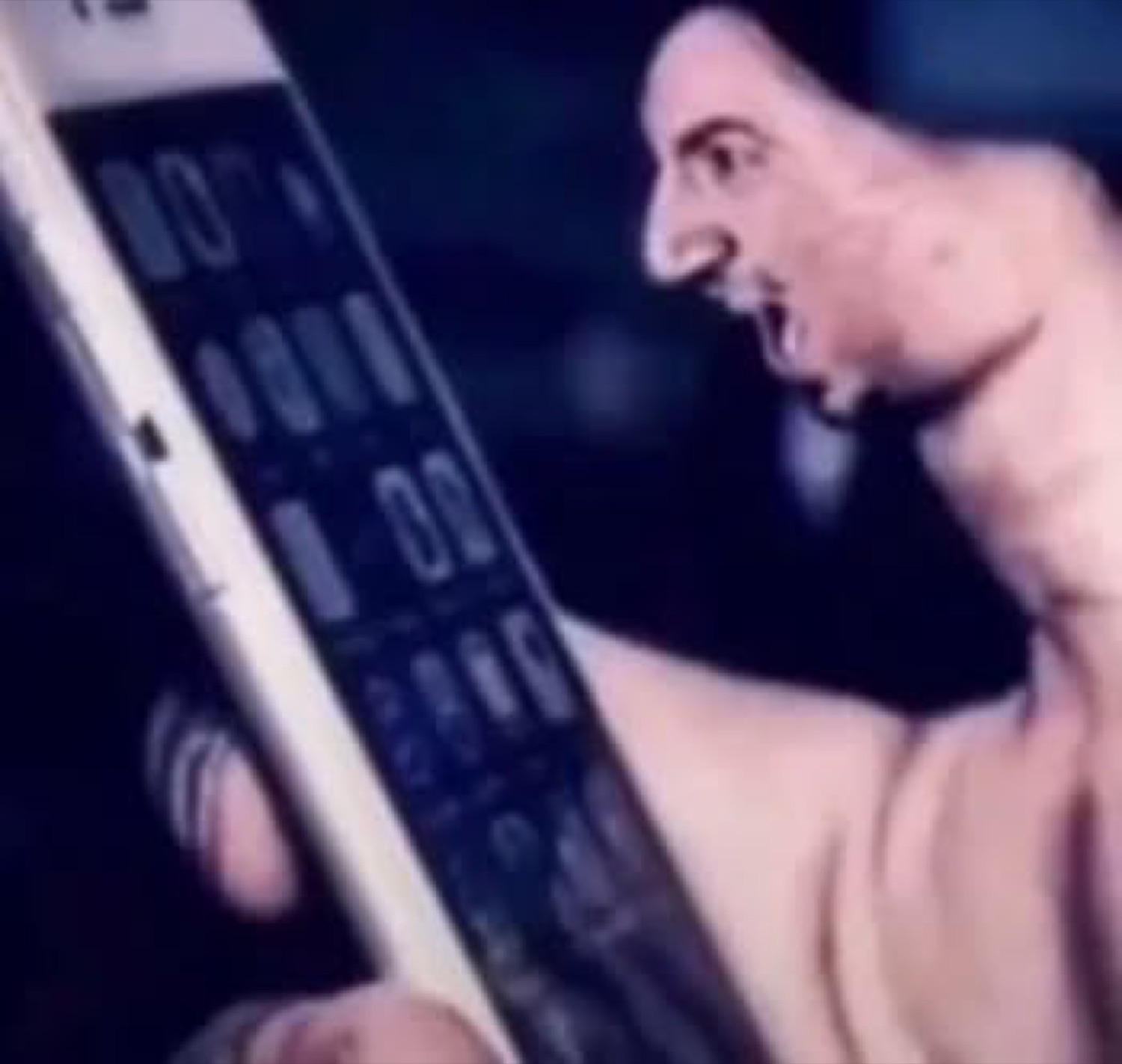Shirtless man screaming furiously at a phone showing a wall of notifications