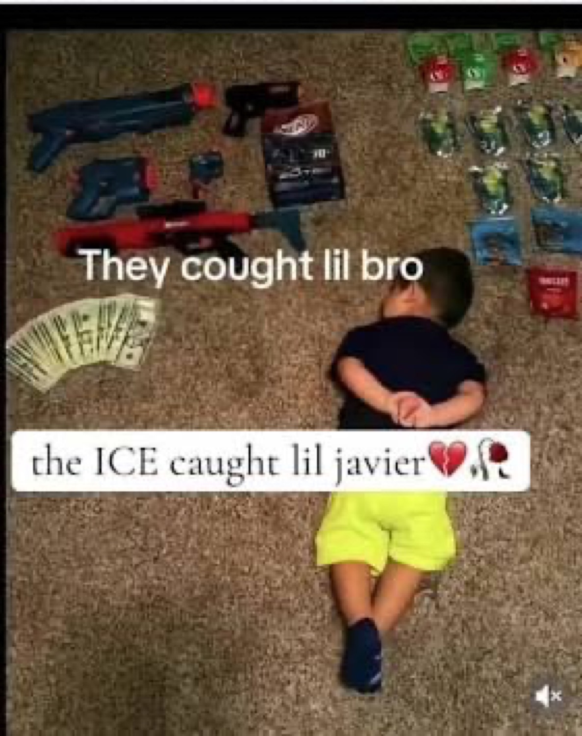 Kid lying on the floor beside toy guns and cash captioned 'the ICE caught lil javier'
