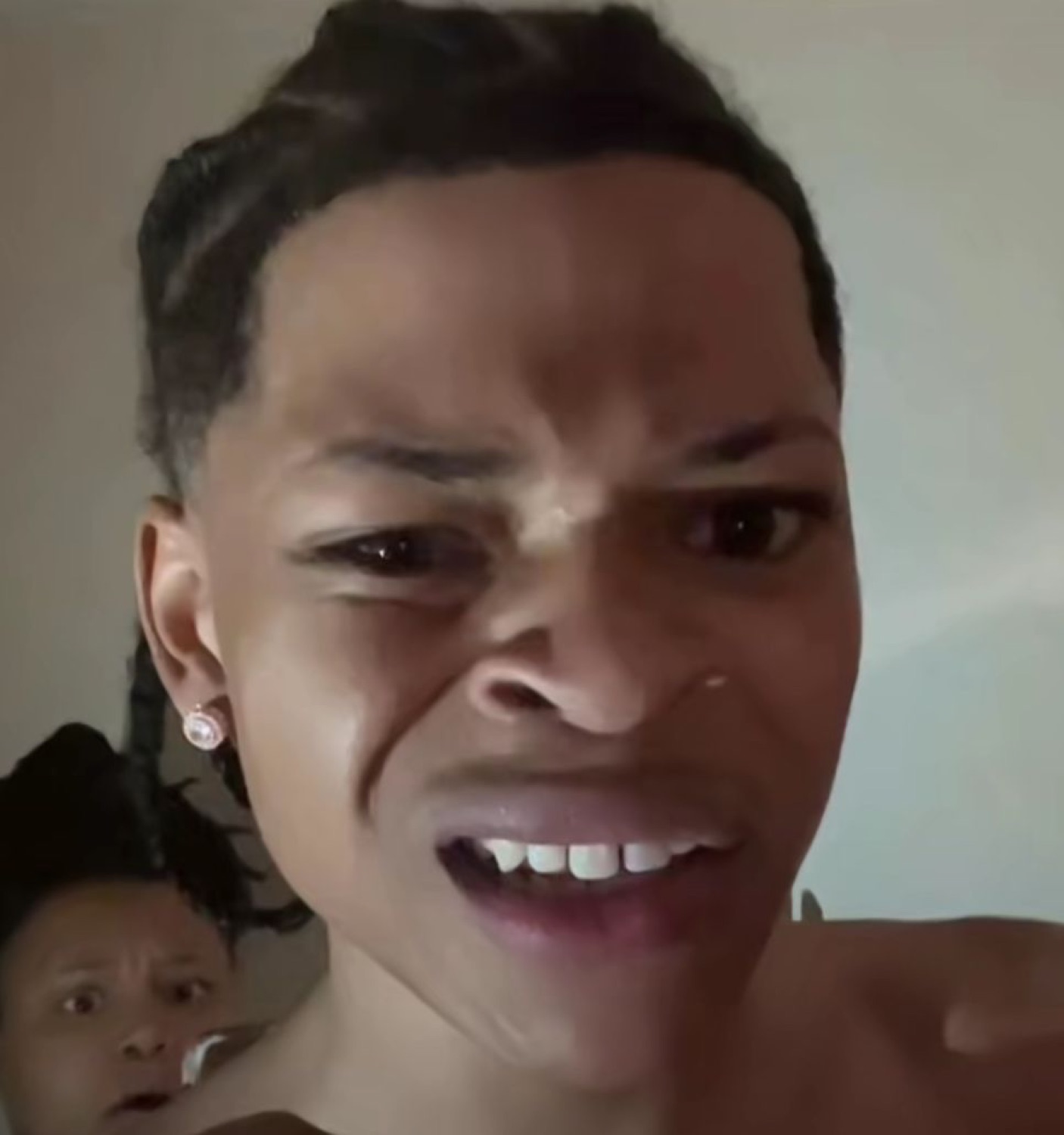 Woman screwing up her face in pure disgust with a sneering snarl
