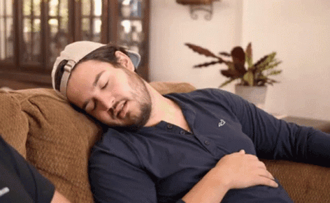 Man on a couch laughing, "Nah, I'm just kidding"