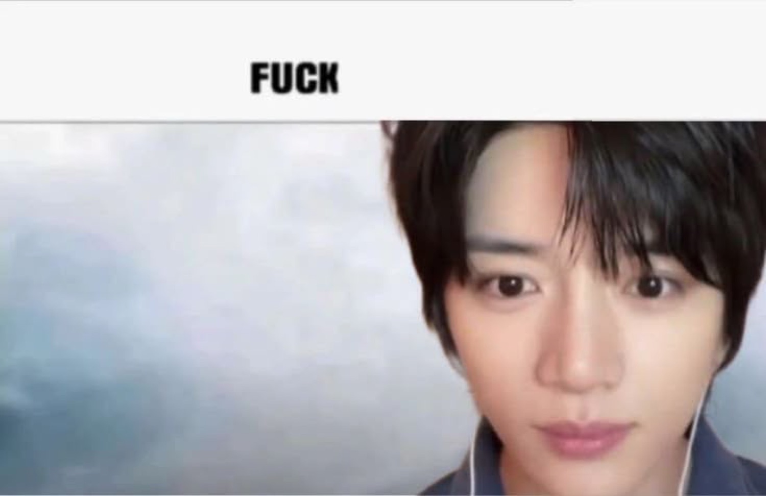 Person staring blankly at the camera with the word 'FUCK' above them