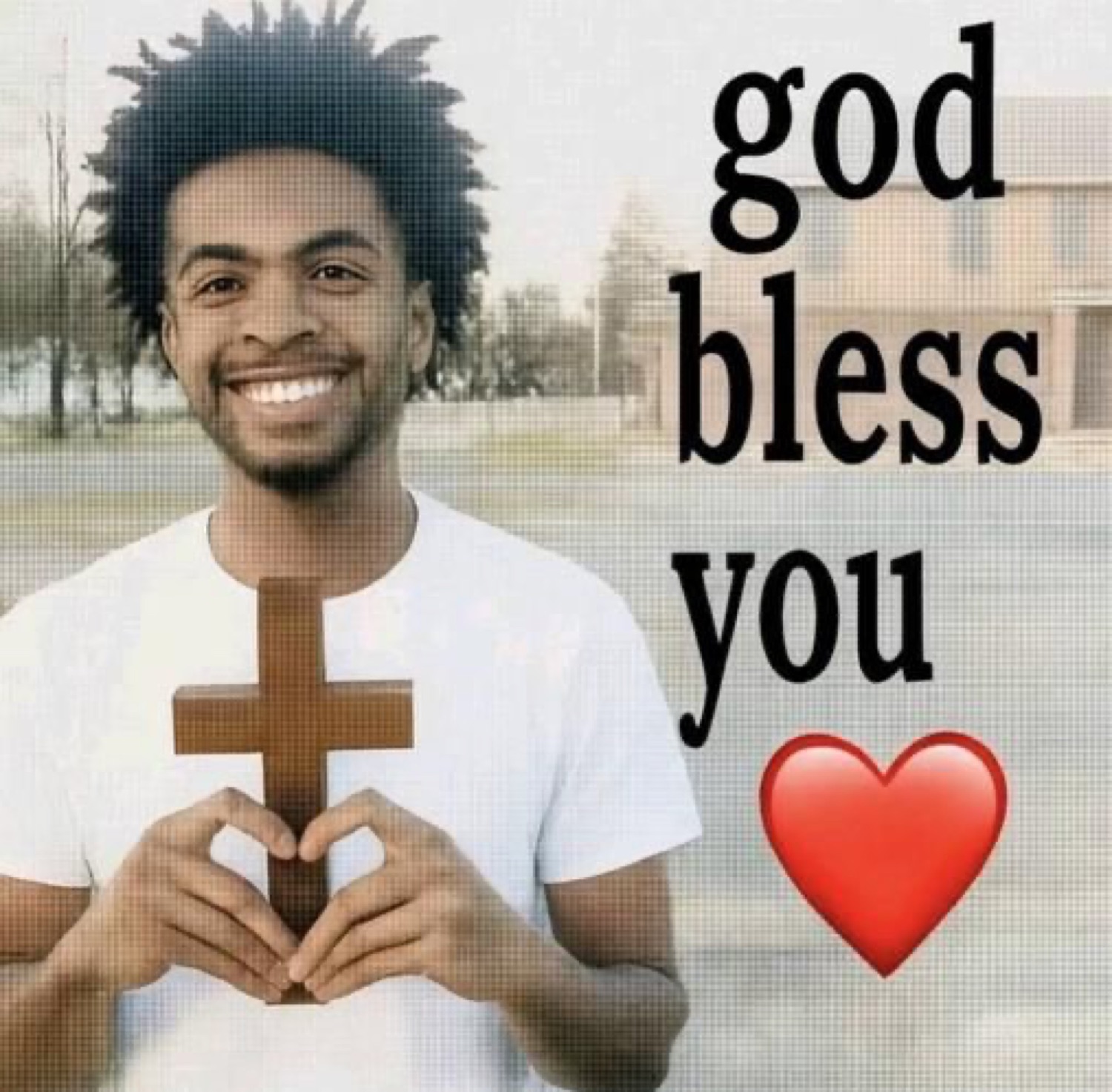 Smiling man holding a wooden cross: 'god bless you' with a heart