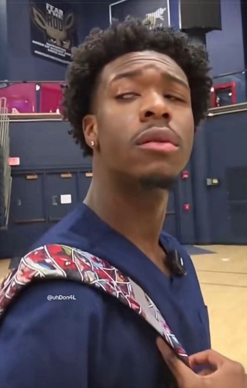 Guy in a gym glancing sideways with a heavy, unimpressed side-eye