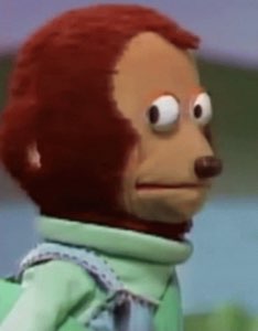 Vintage puppet monkey in a green jacket giving an uncomfortable side-eye