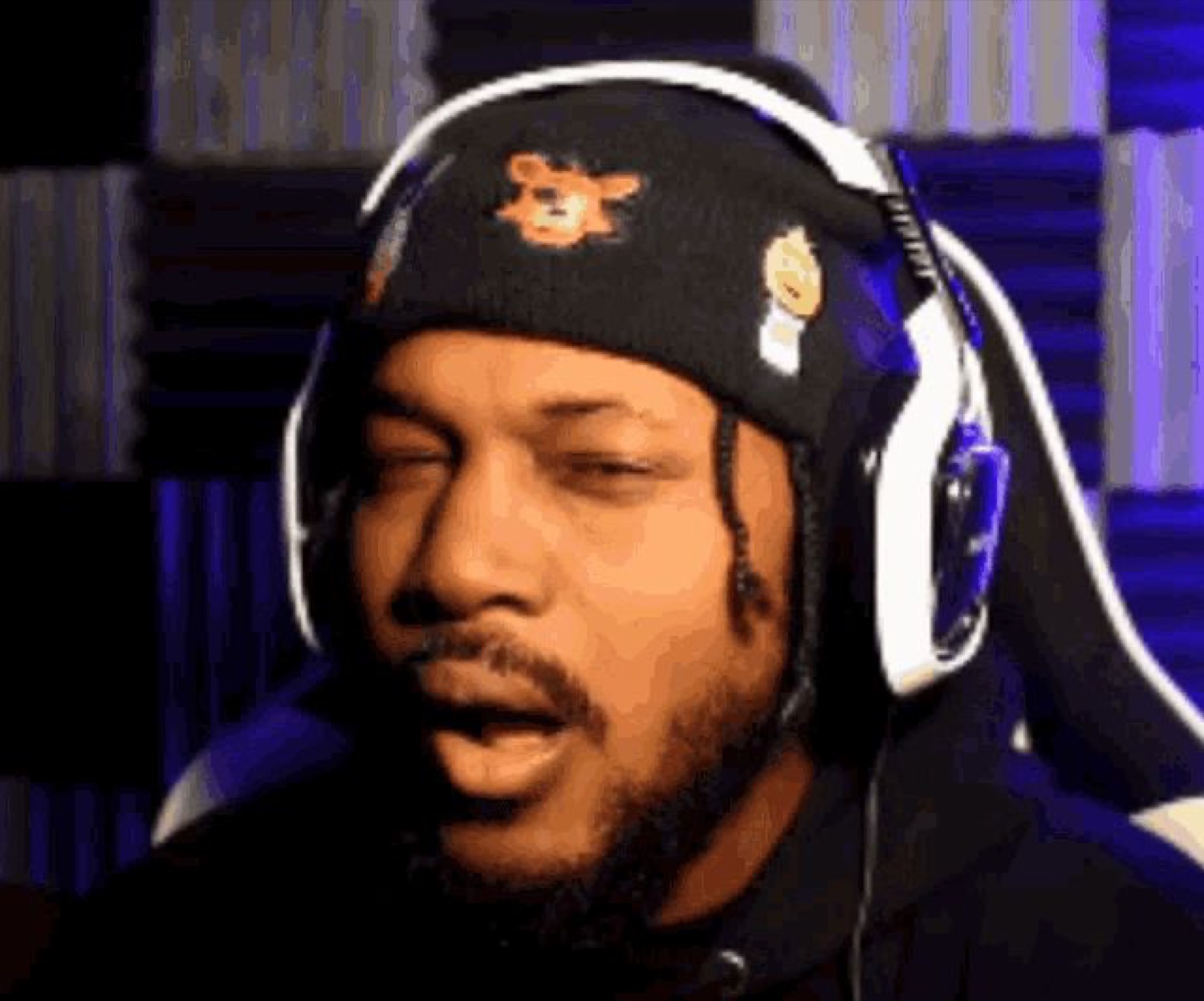 Streamer in a beanie and headset with eyes half shut, completely over it
