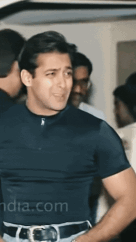 Salman Khan in a black t-shirt turning around in a crowd
