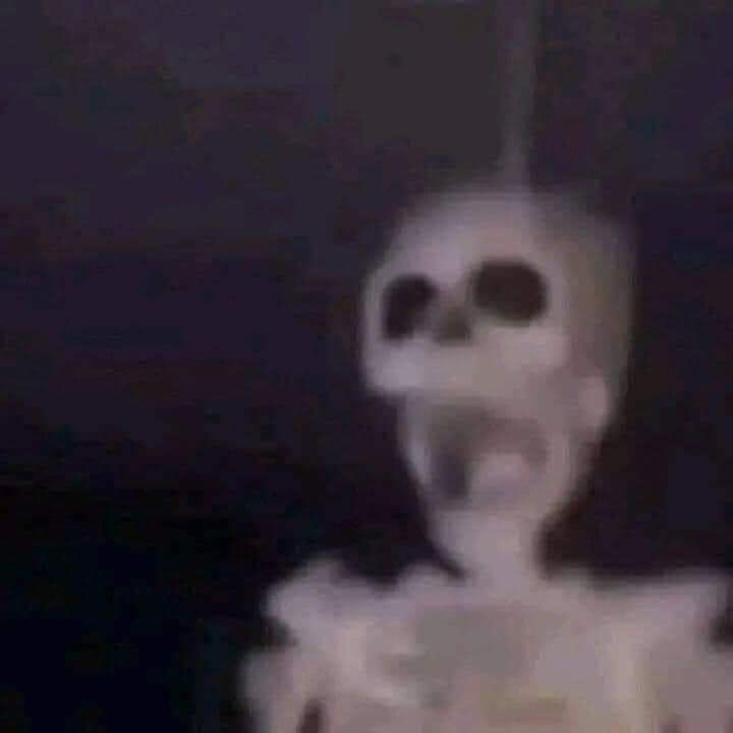 Blurry screaming skeleton in the dark