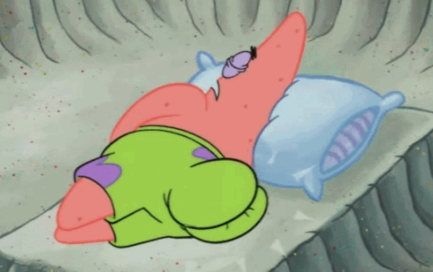 Patrick Star passed out asleep with his mouth open, cuddled up on a rock with a pillow
