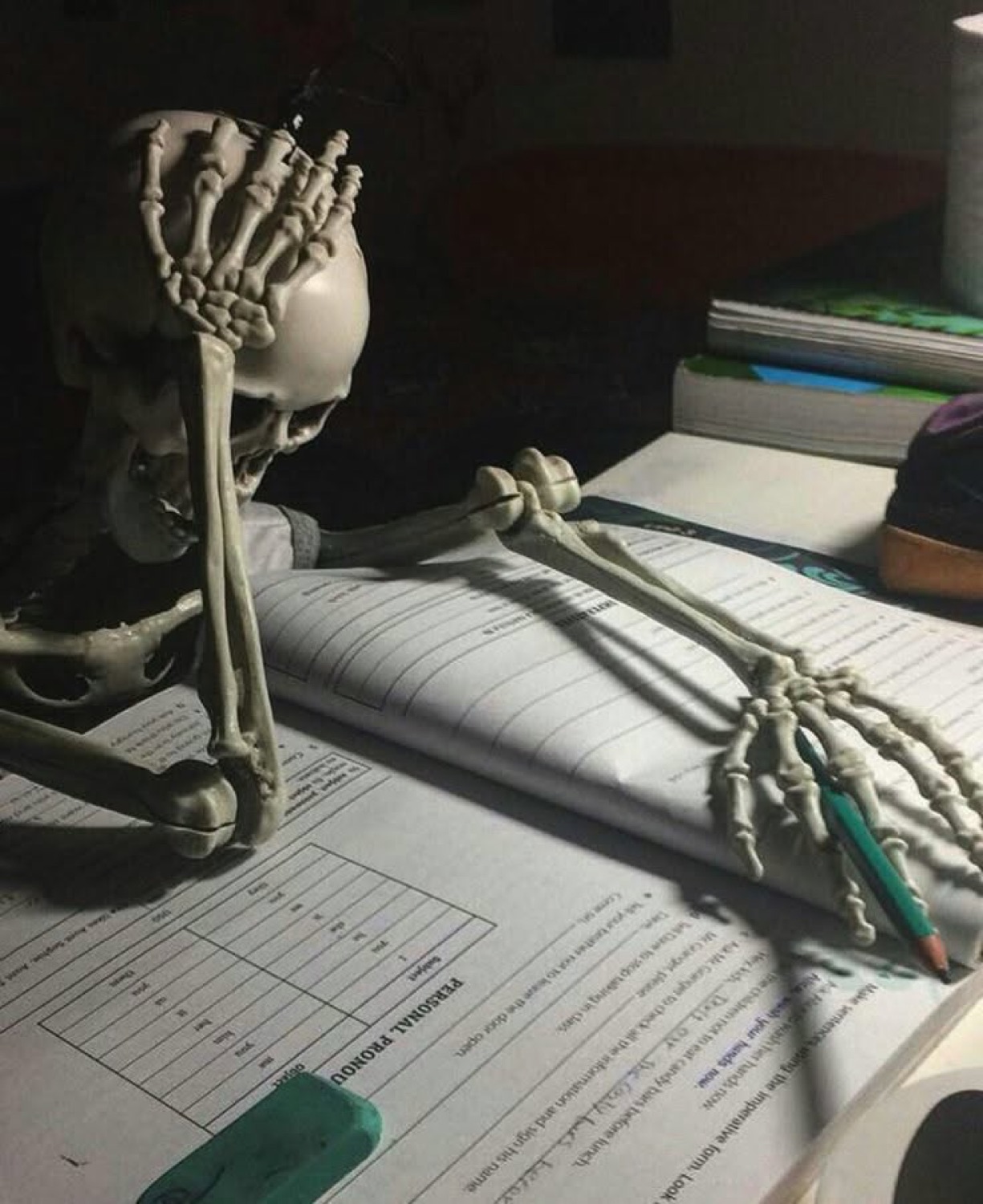 Skeleton slumped over a worksheet with its head in its hand