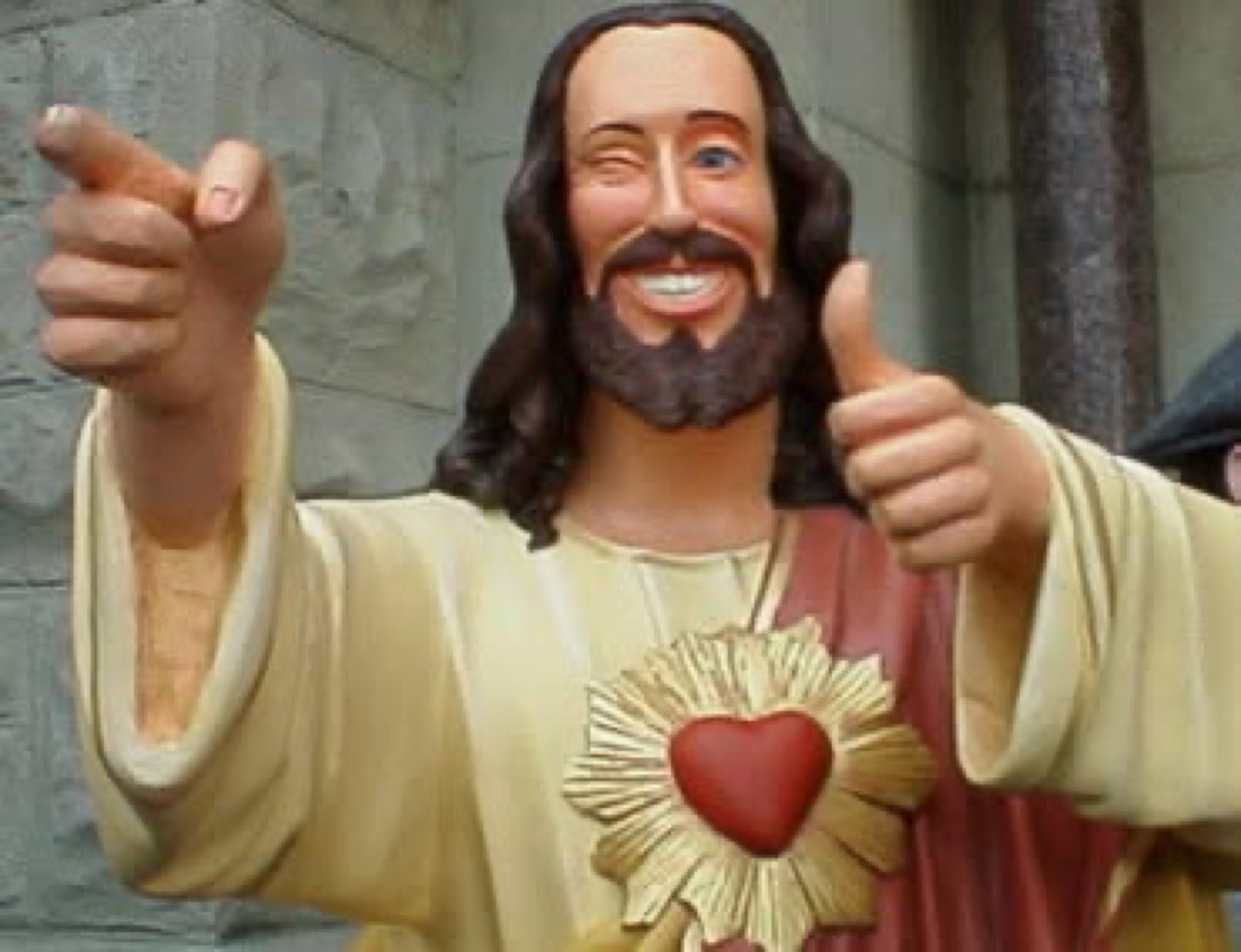 Buddy Christ statue winking with a thumbs up and finger gun