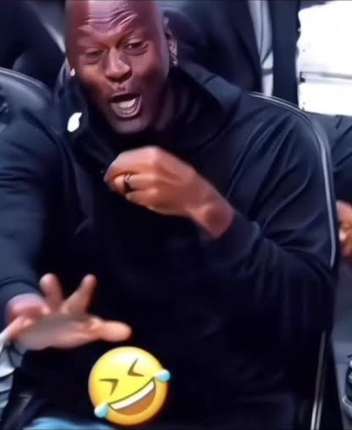 Michael Jordan laughing hysterically courtside with a laughing-crying emoji