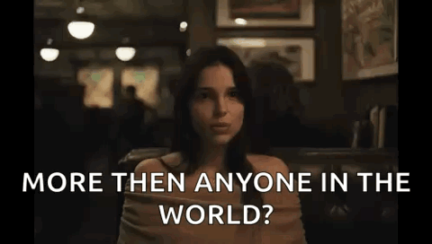 Woman at a restaurant table smiling, "More than anyone in the world?"