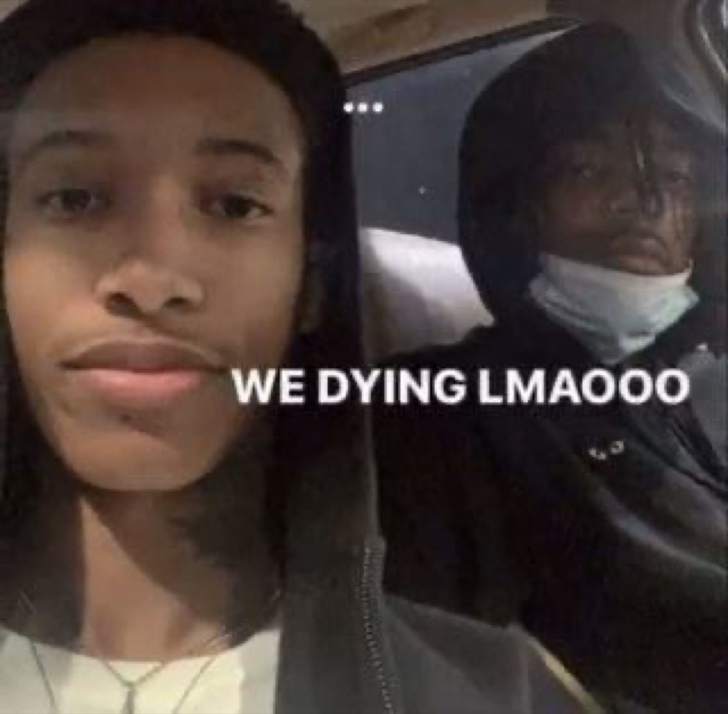 Two friends in a car with blank faces captioned 'WE DYING LMAOOO'