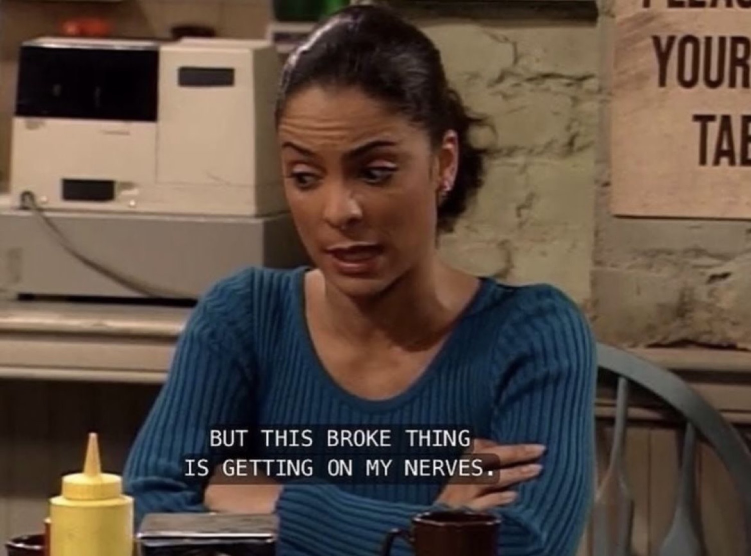 Woman in a blue sweater exasperated with her hand on her chest captioned 'BUT THIS BROKE THING IS GETTING ON MY NERVES.'