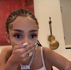 Young woman covering her mouth with her hand, eyes wide in shocked disbelief