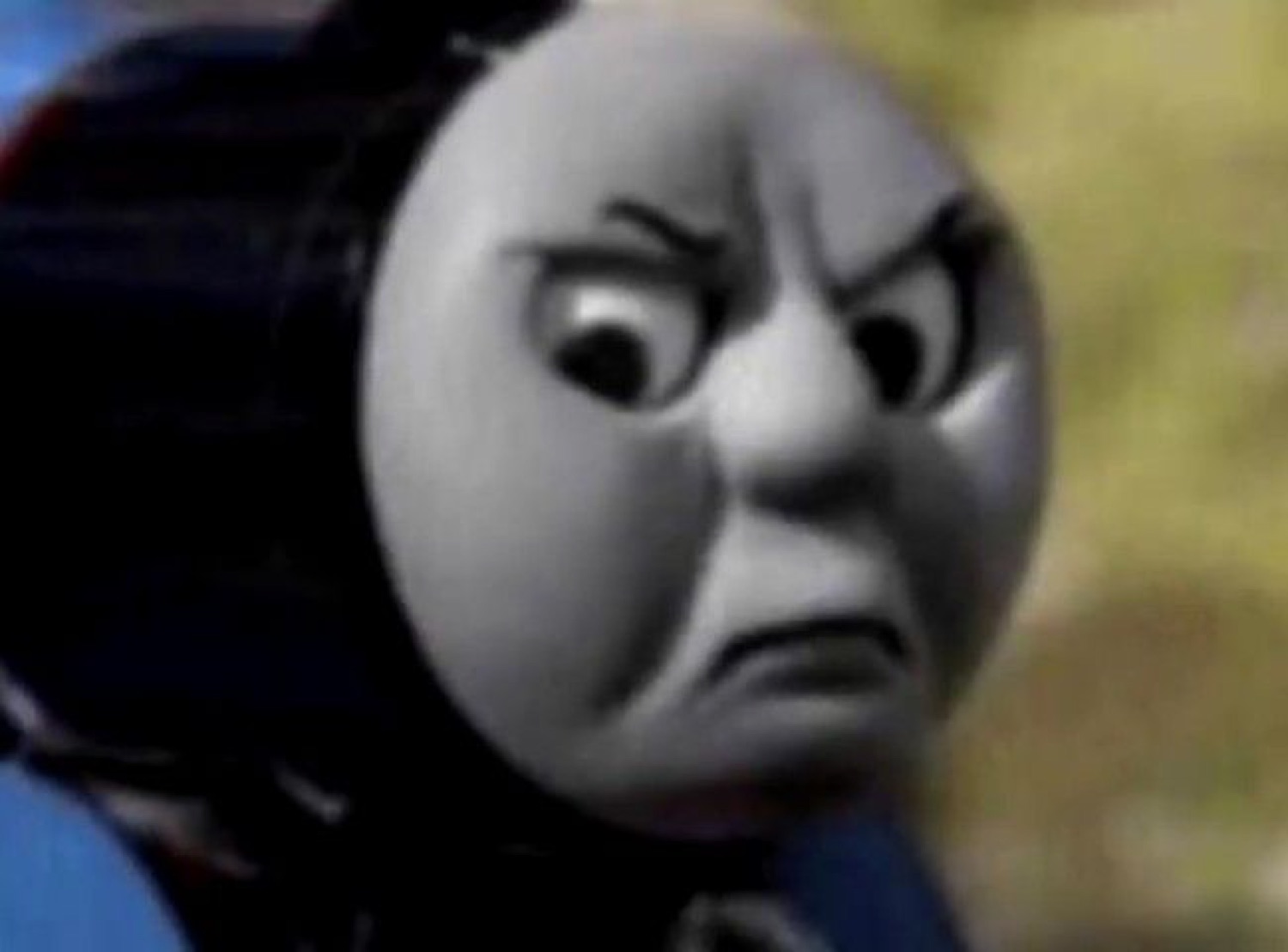 Thomas the Tank Engine up close with a deeply furious, scowling expression