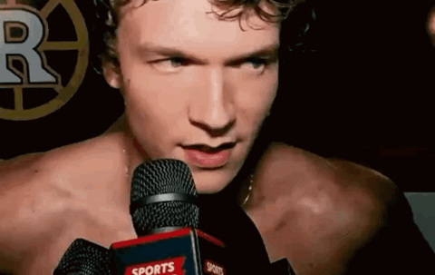 ilya rozanov hockey player in a post-game interview smirking into the microphones
