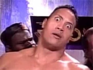 The Rock turning to camera with wide-eyed, eyebrow-raised disbelief