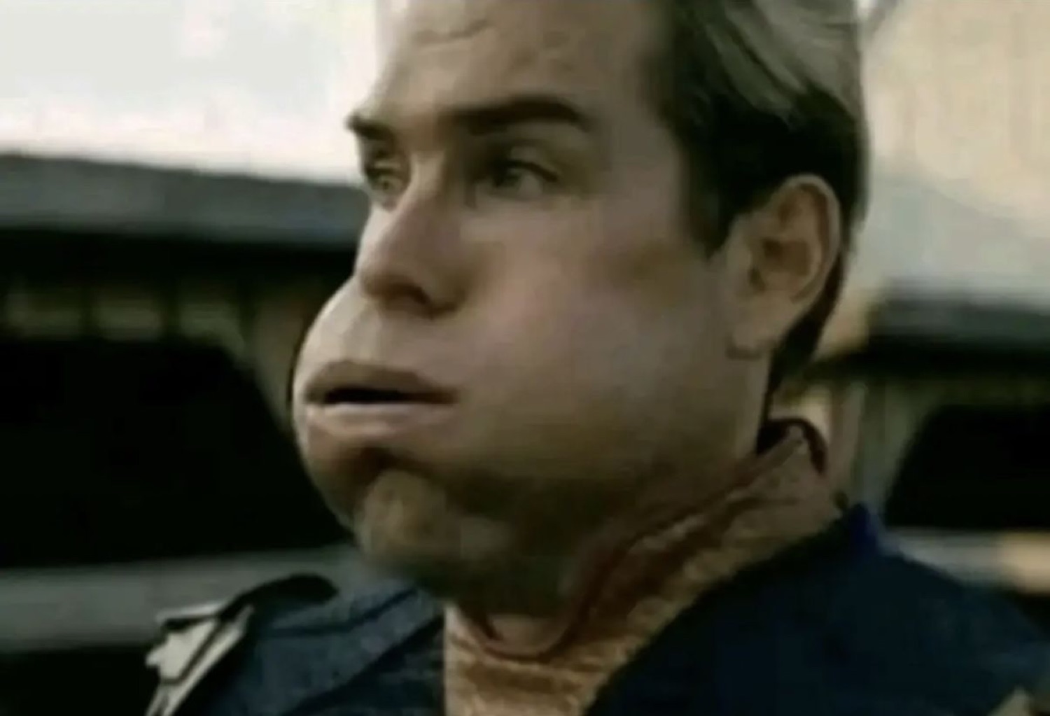 Man with a comically squished, distorted face giving a puzzled sideways look