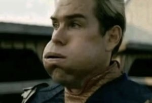 Man with a comically squished, distorted face giving a puzzled sideways look