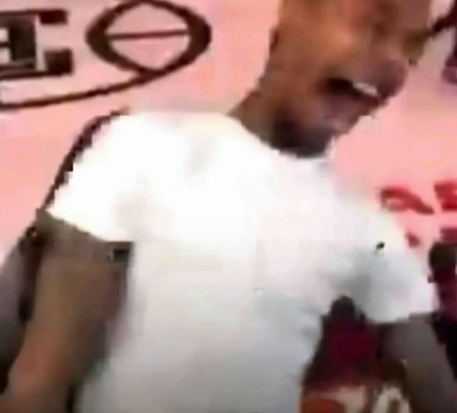 Low-quality clip of a guy in a white tee screaming with excitement mid-motion