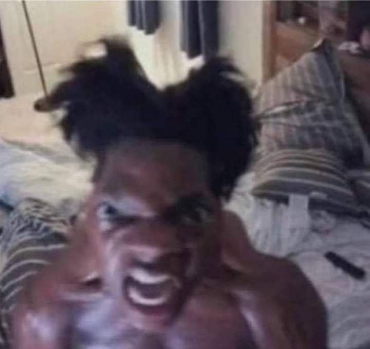 Shirtless man mid-scream with wild hair, veins bulging in pure rage