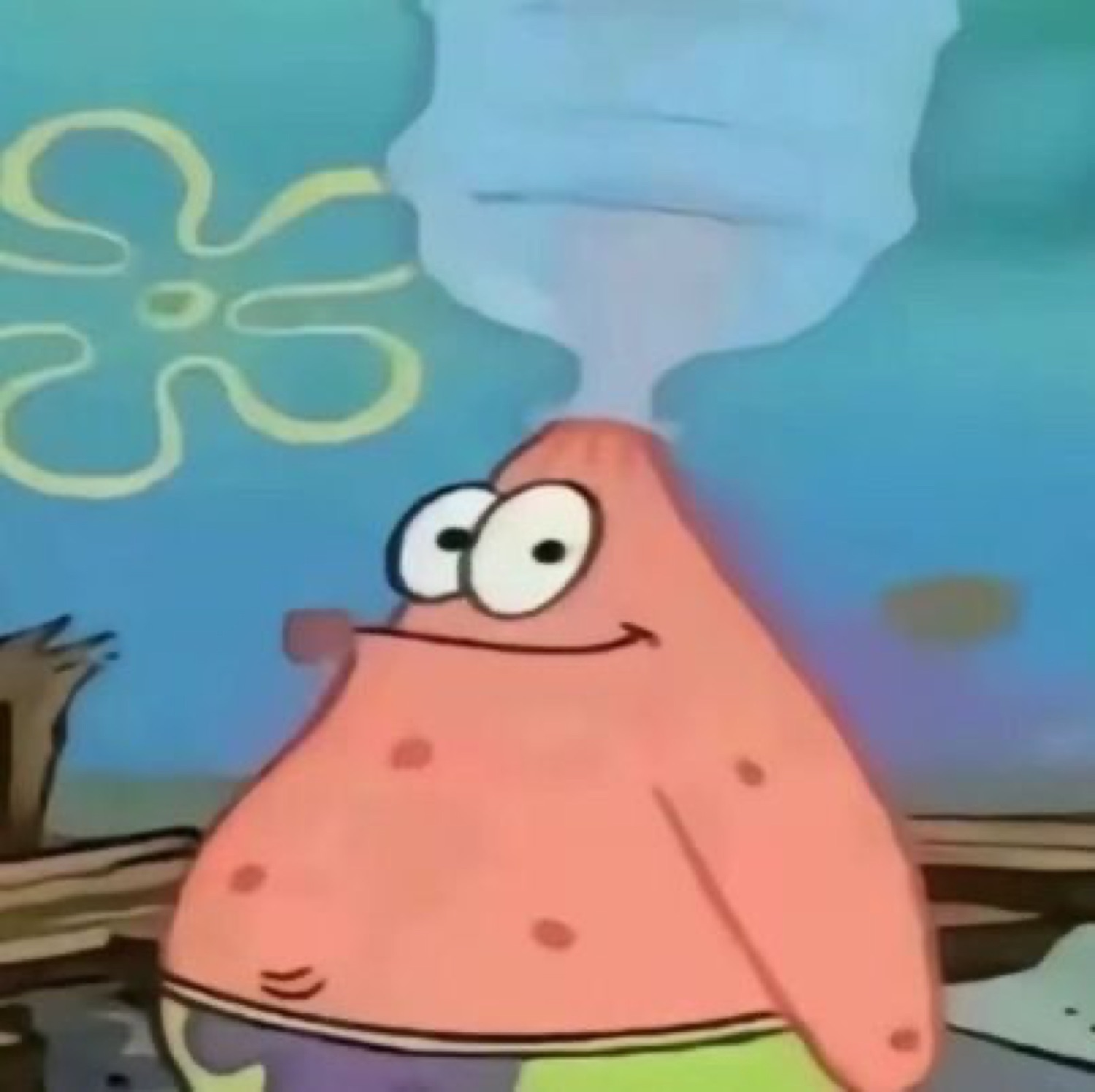 Patrick Star with a puff of smoke rising off his head, grinning