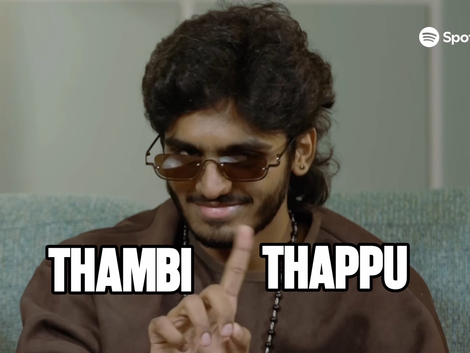 Man in sunglasses wagging a finger: 'THAMBI THAPPU' (brother, that's wrong)