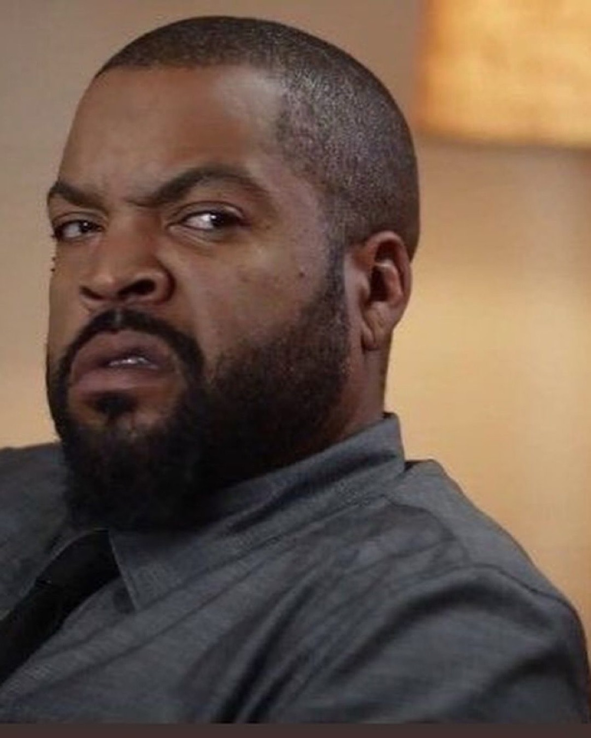 Ice Cube cutting his eyes sideways with maximum skepticism and zero interest
