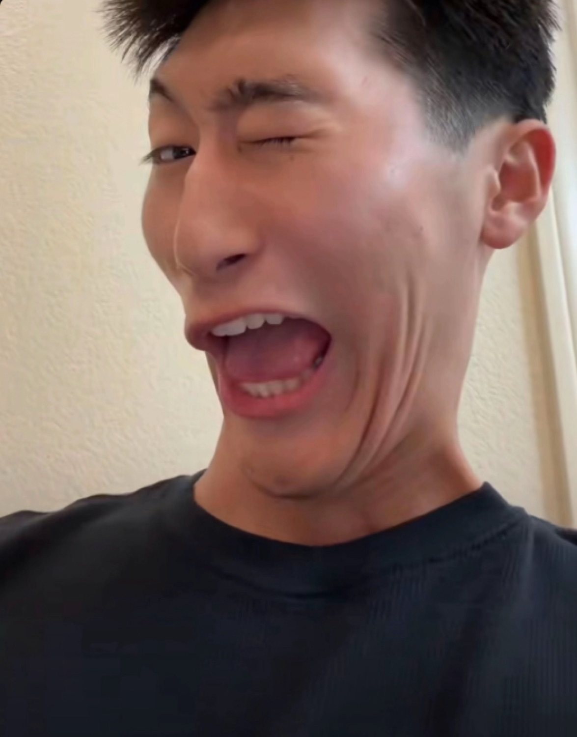 Man with one eye winked and mouth stretched wide in an exaggerated wail