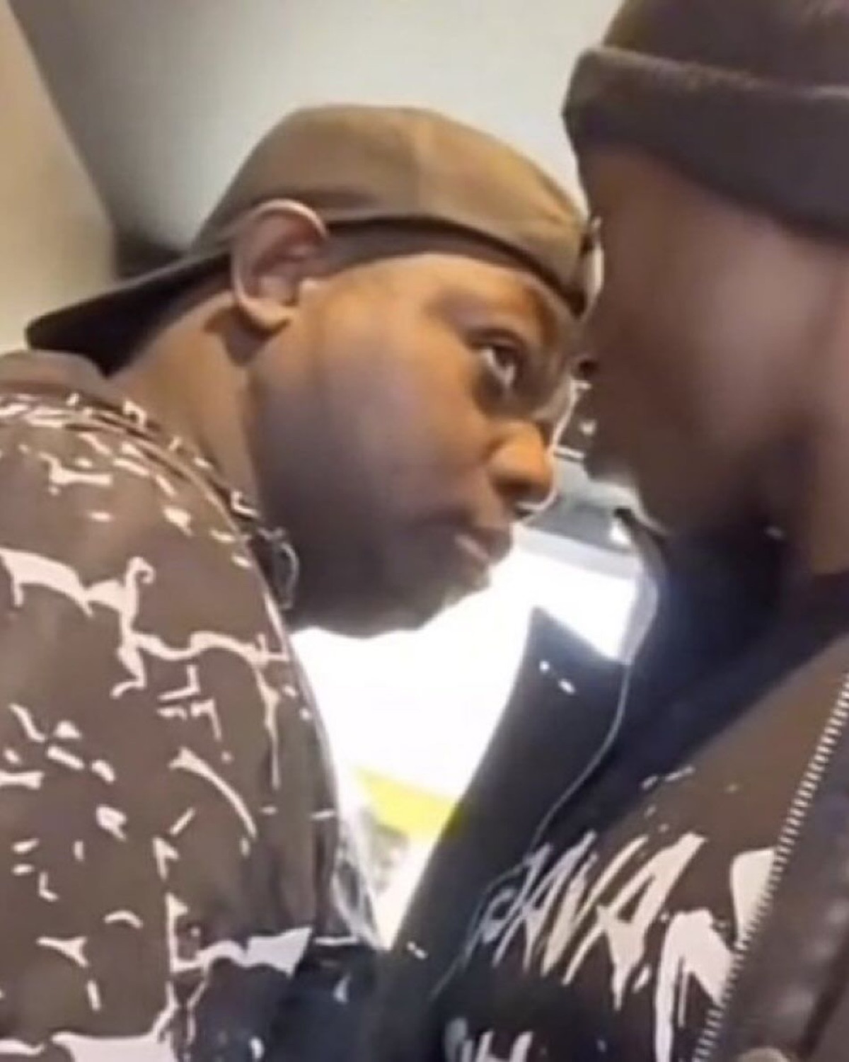 Two men face to face, one eyeing the other with intense suspicion